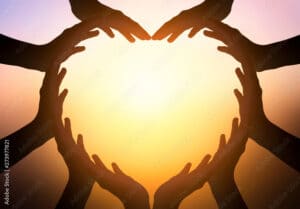 International Day of Friendship concept: hands in shape of heart on blurred background